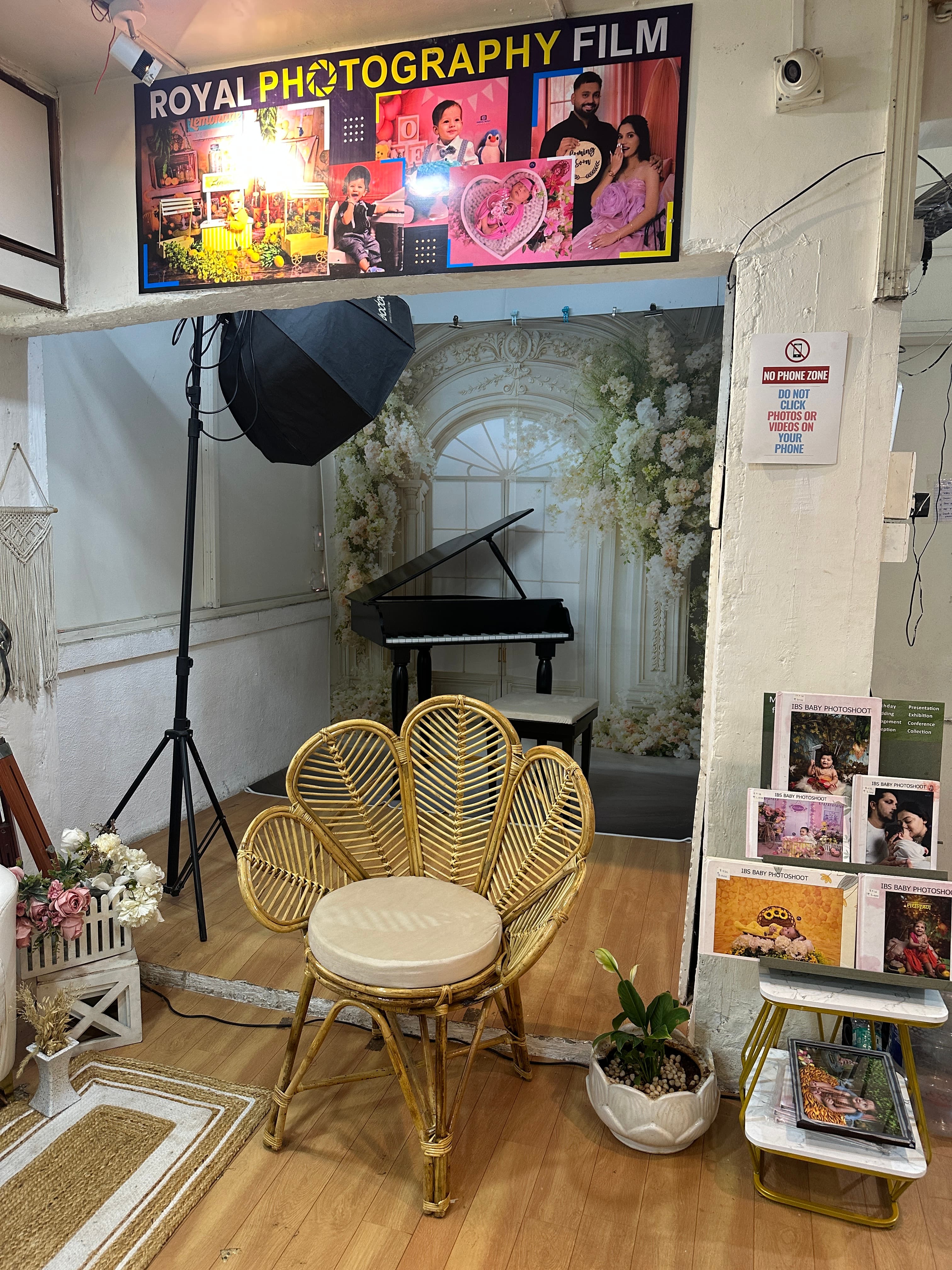 Royal Photography Films branding wall and styled piano set inside IBS studio