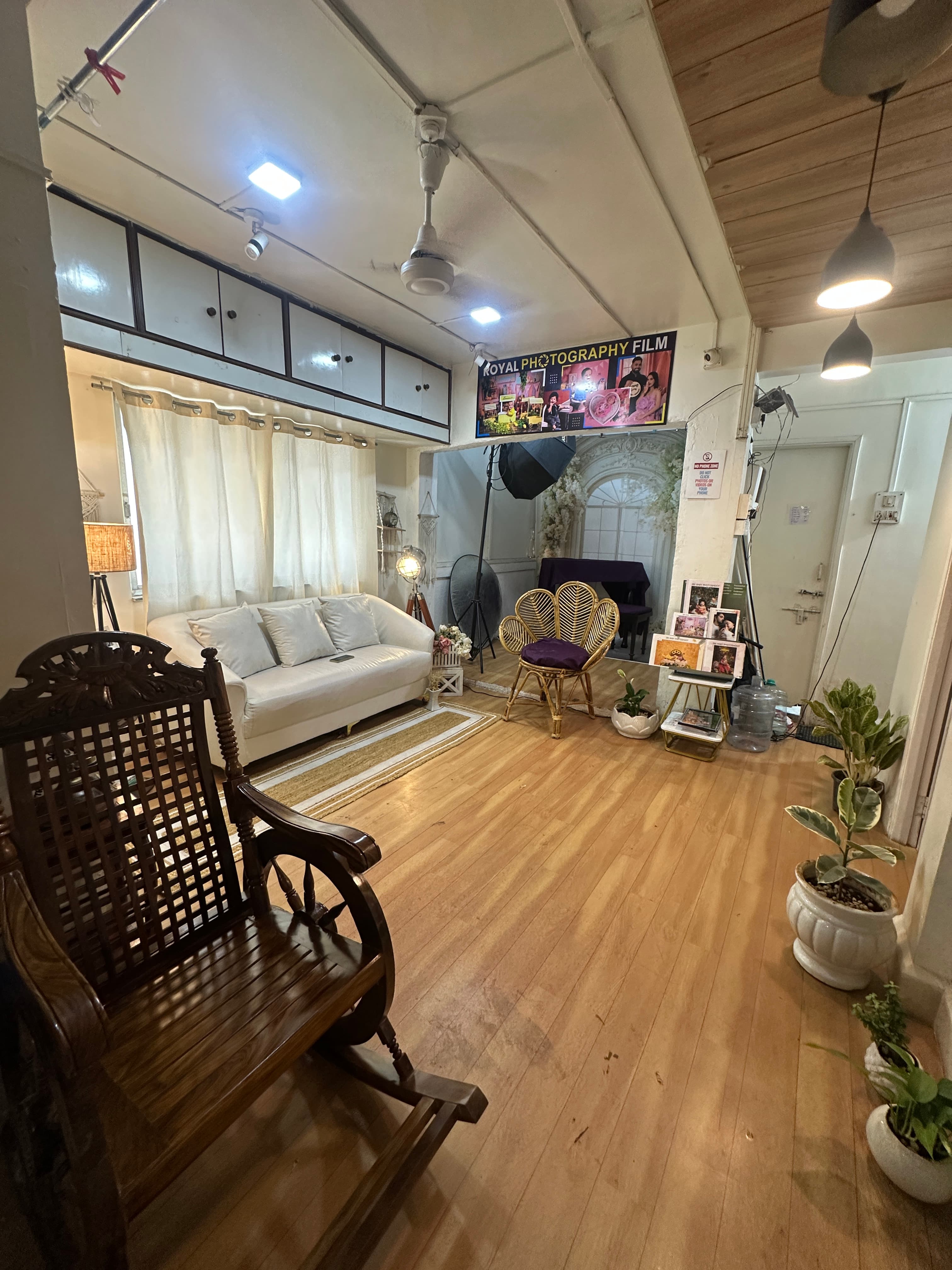 Studio seating area with sofa decor and styled photo set in the IBS baby studio